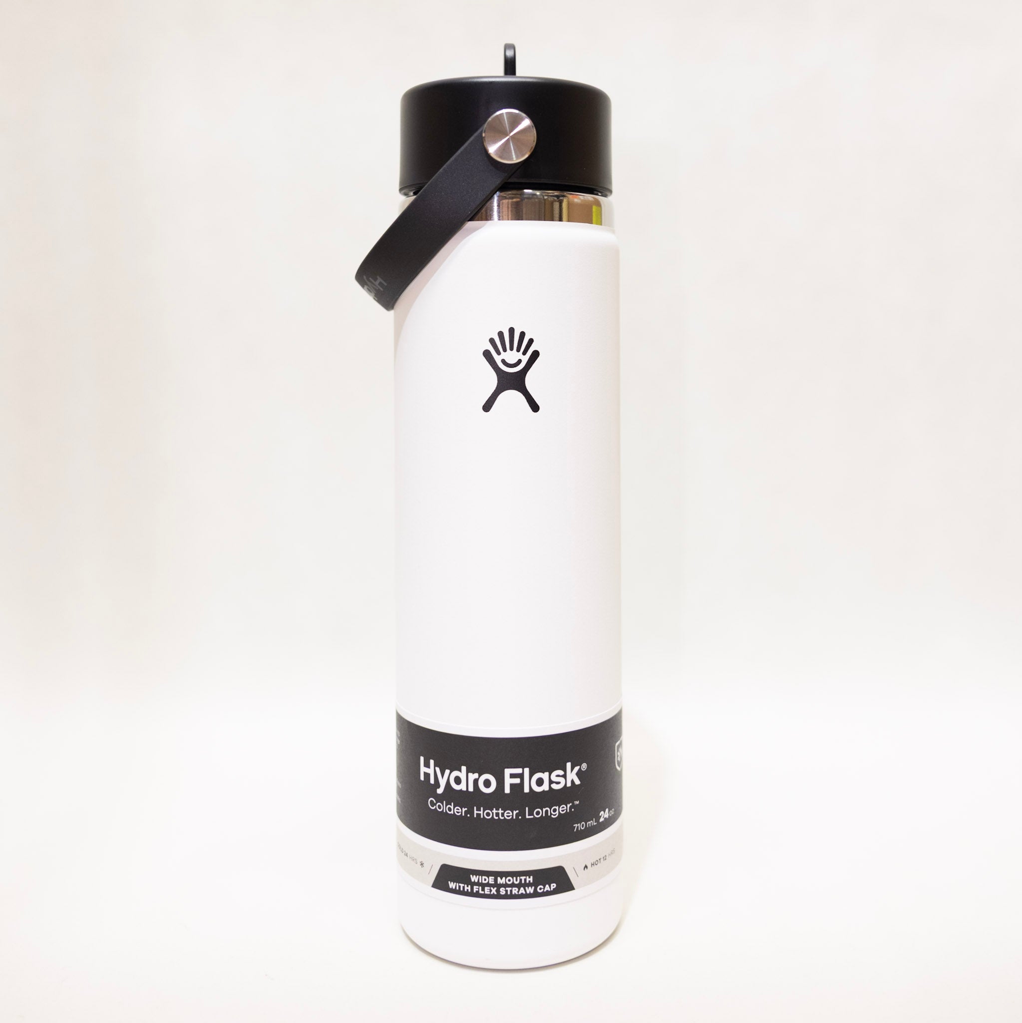 White Hydro Flask water bottle with black lid on a white background