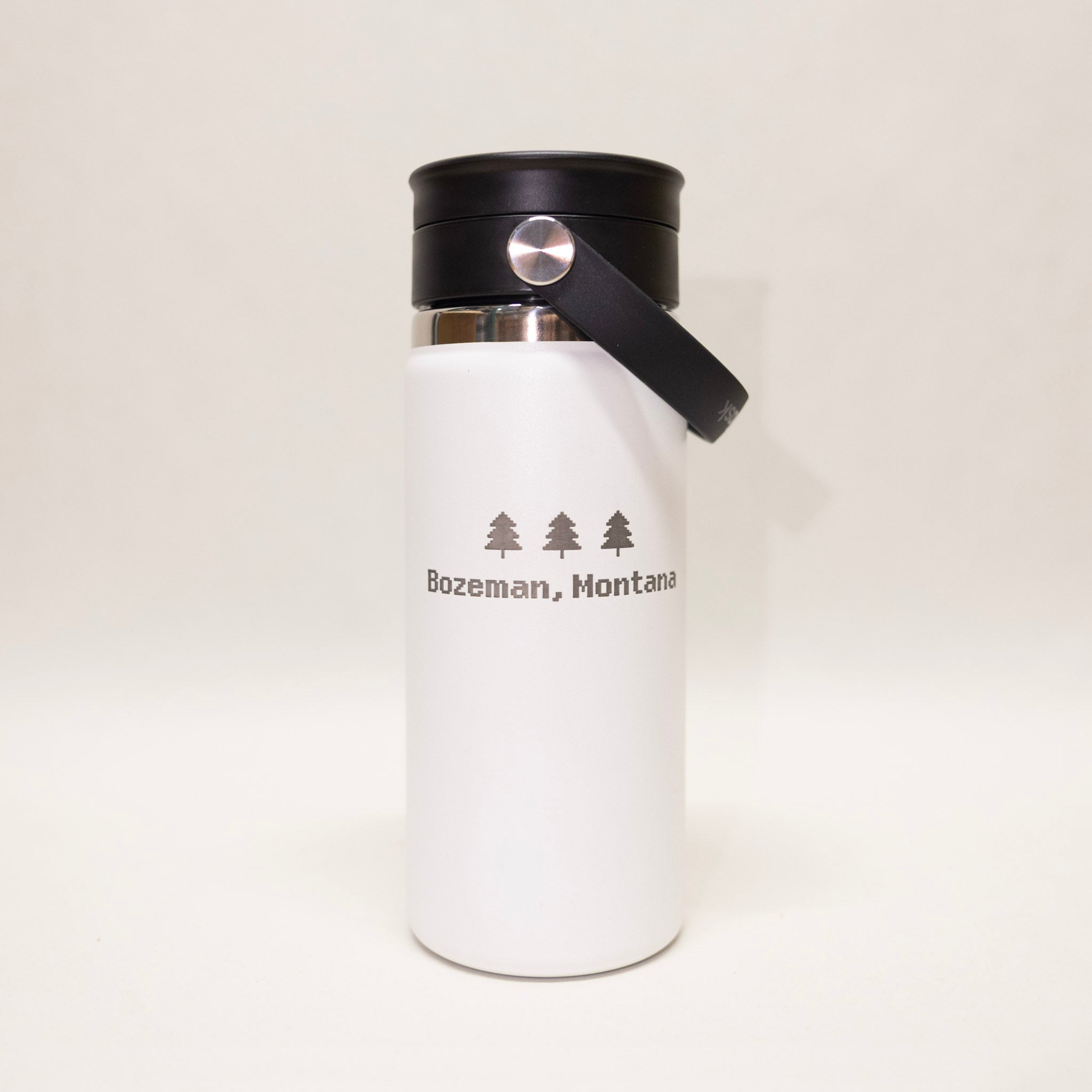 White insulated bottle with black lid and 'Bozeman, Montana' text on a white background
