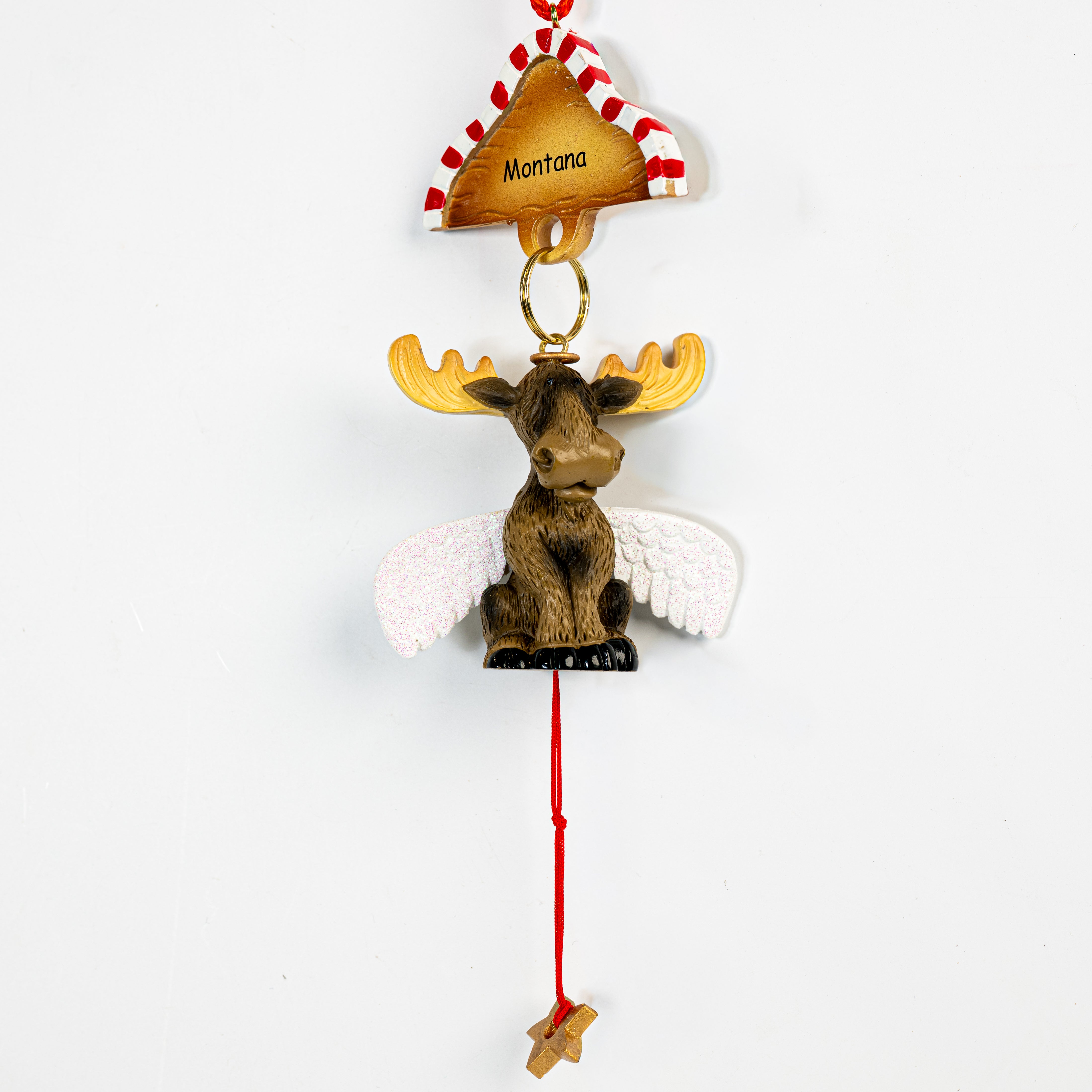 Decorative moose ornament with wings and 'Montana' sign on a white background