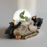 Decorative figurine with two bears around a rock and water globe on a white background