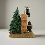 Decorative figurine with a tree, log, and bear on a white background