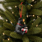 Bearfoots bear playing a drum Christmas ornament with a red ribbon