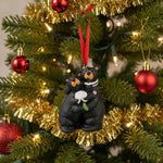 Decorative ornament of two bears holding a heart and a flower, with a red ribbon on a white background.