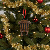 Decorative ornament of a bear and cub on a rocking chair with a red ribbon on a white background