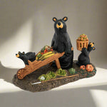 Decorative figurine of bears around a table with vegetables and a basket on a white background