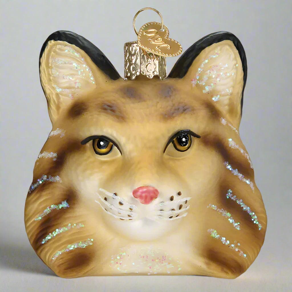Glass bobcat ornament with glittery details on a white background