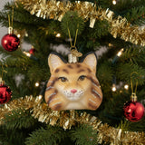 Glass bobcat ornament with glittery details on a white background