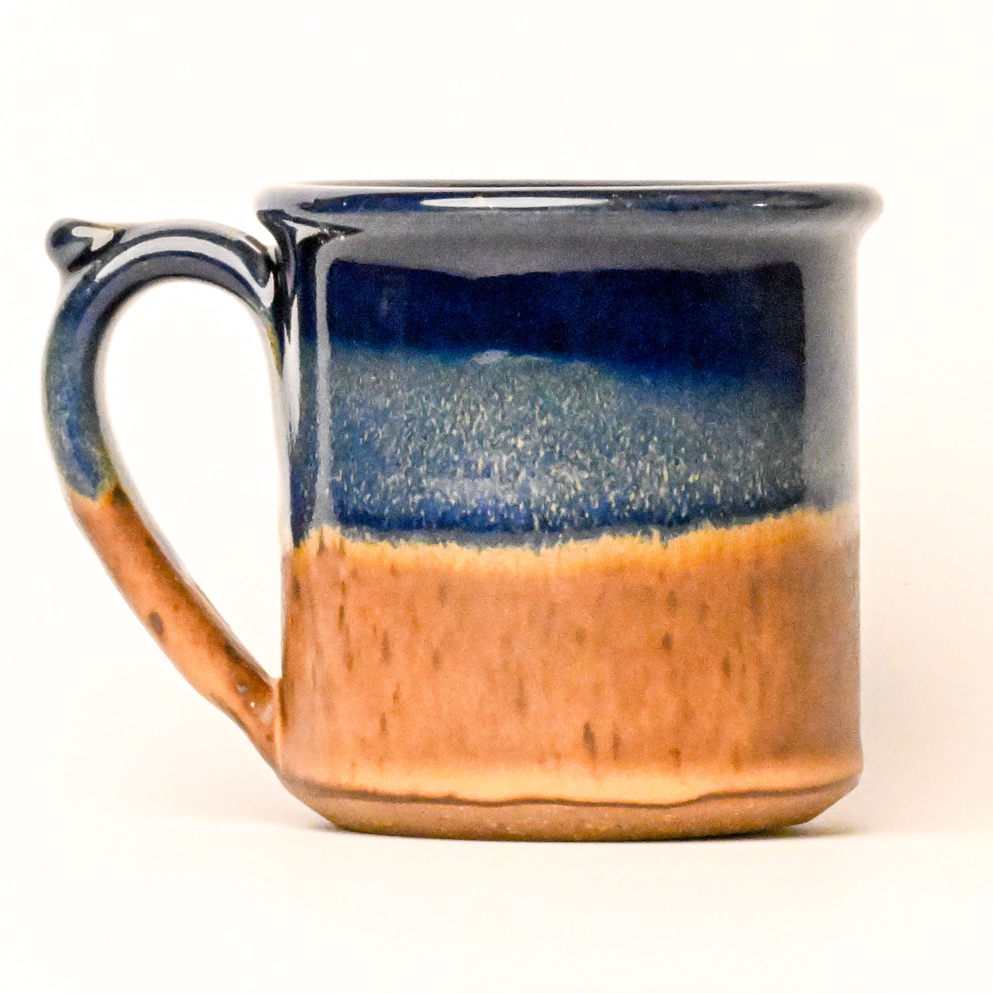Ceramic mug with blue and brown gradient on a white background
