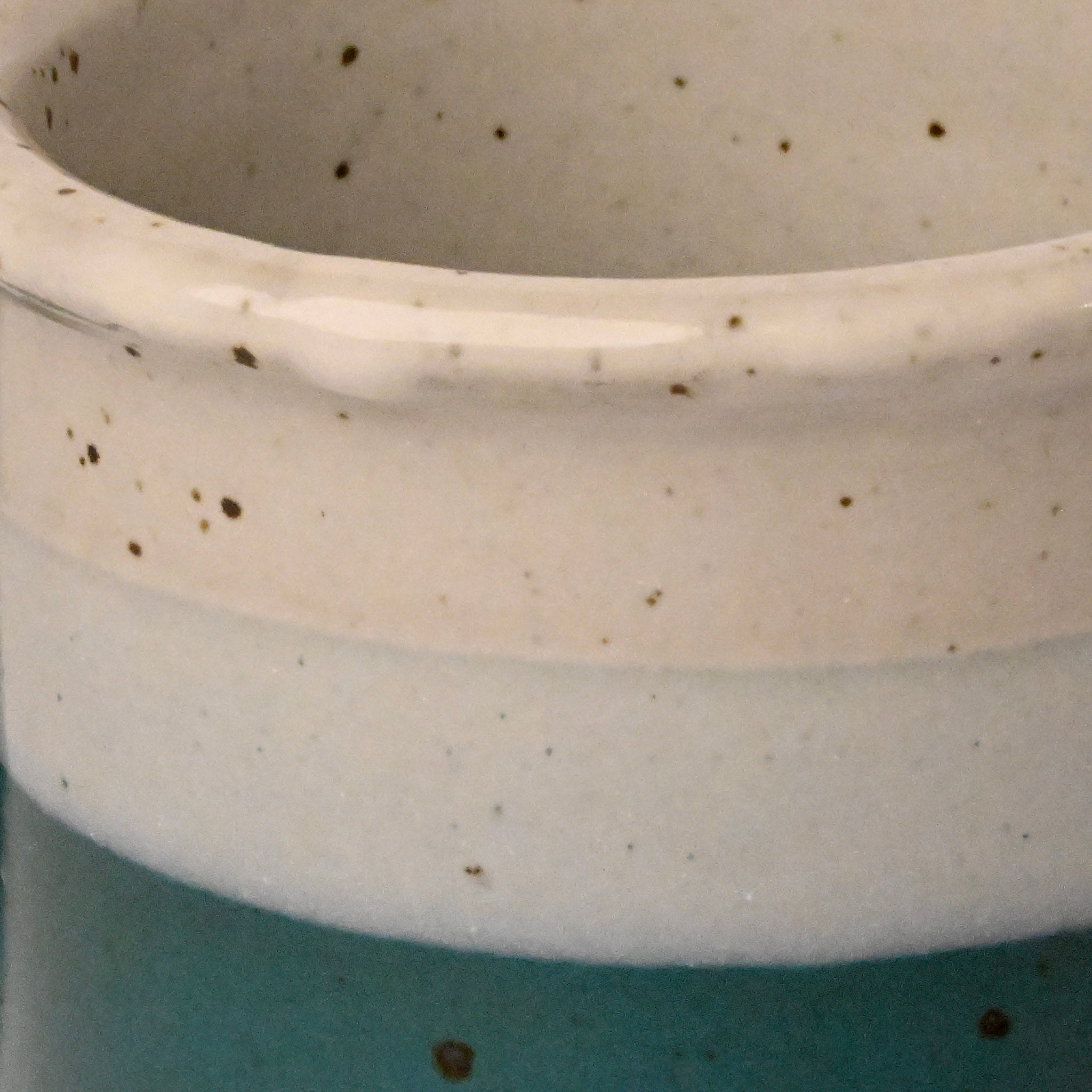 Close-up of a ceramic pot with speckled glaze