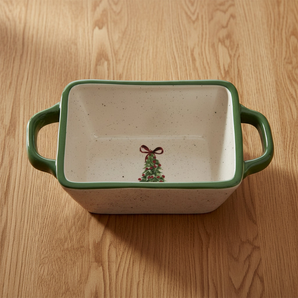 Rectangular ceramic dish with green handles and a Christmas tree design on a white background