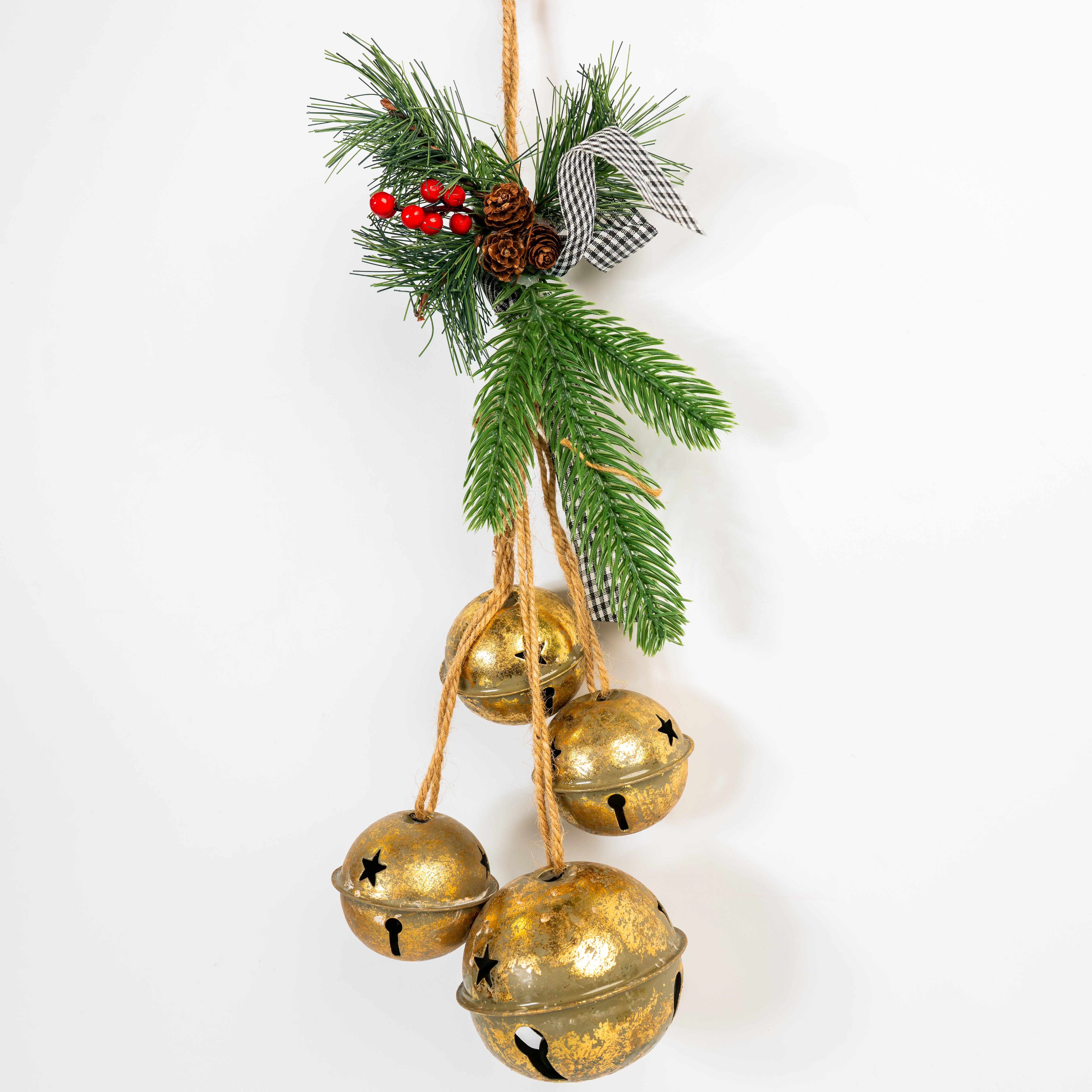 Decorative hanging with gold jingle bells, greenery, and pinecones on a white background