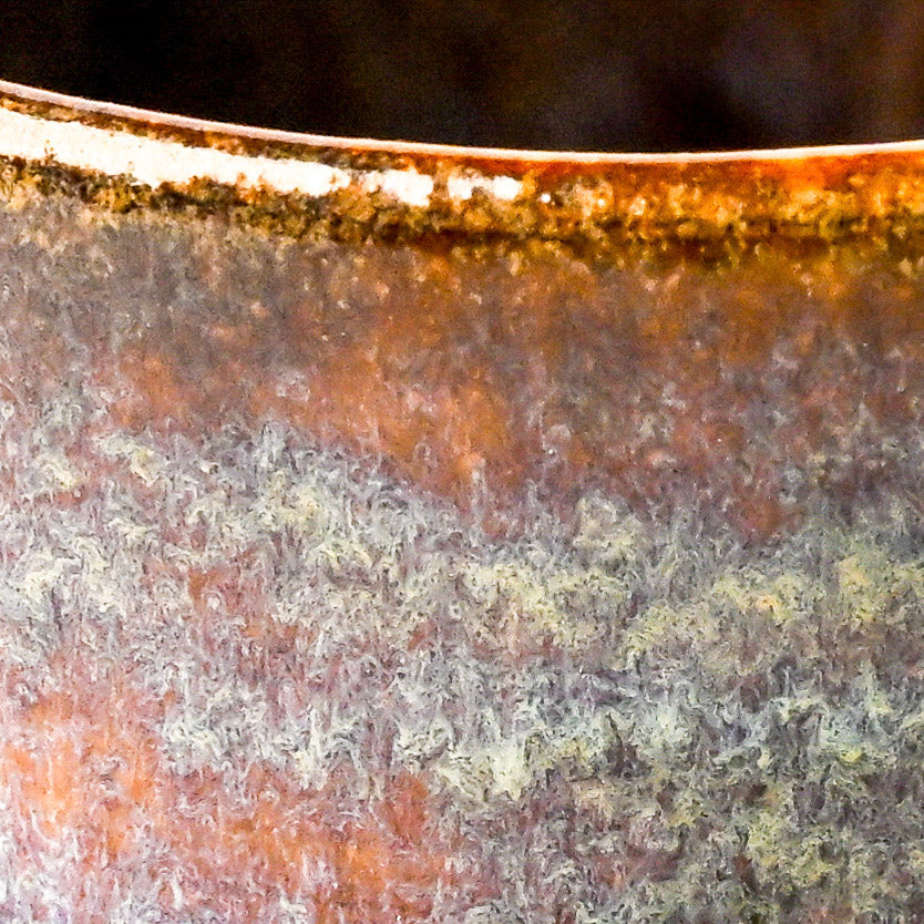 Close-up of a textured ceramic surface with purple and blue glaze