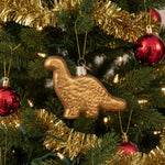 Gold glitter dinosaur-shaped Christmas ornament on a white background