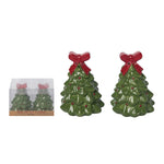 Green Christmas tree-shaped salt and pepper shakers with red bows on a white background