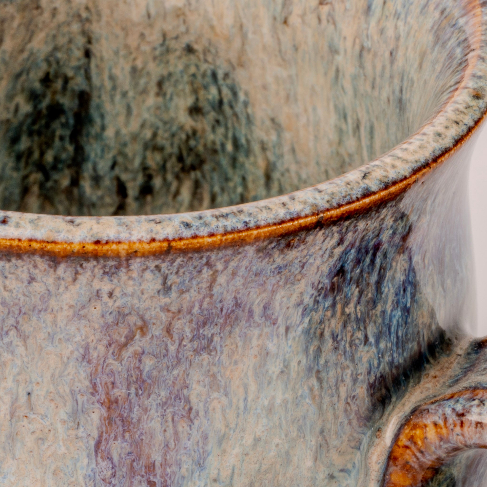 Close-up of a ceramic pot with textured surface and visible glaze.