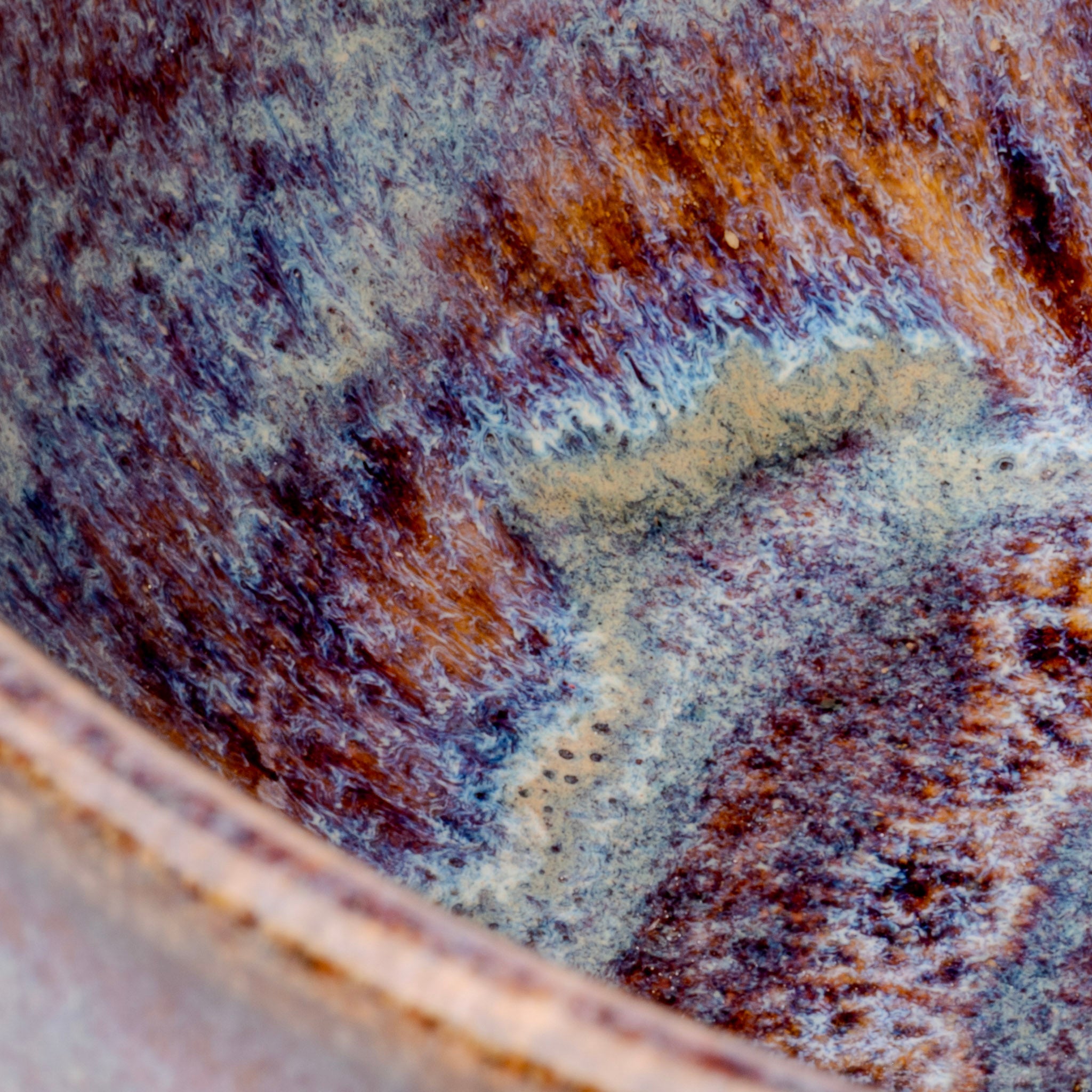 Close-up of a rusted metal surface with brown and purple hues