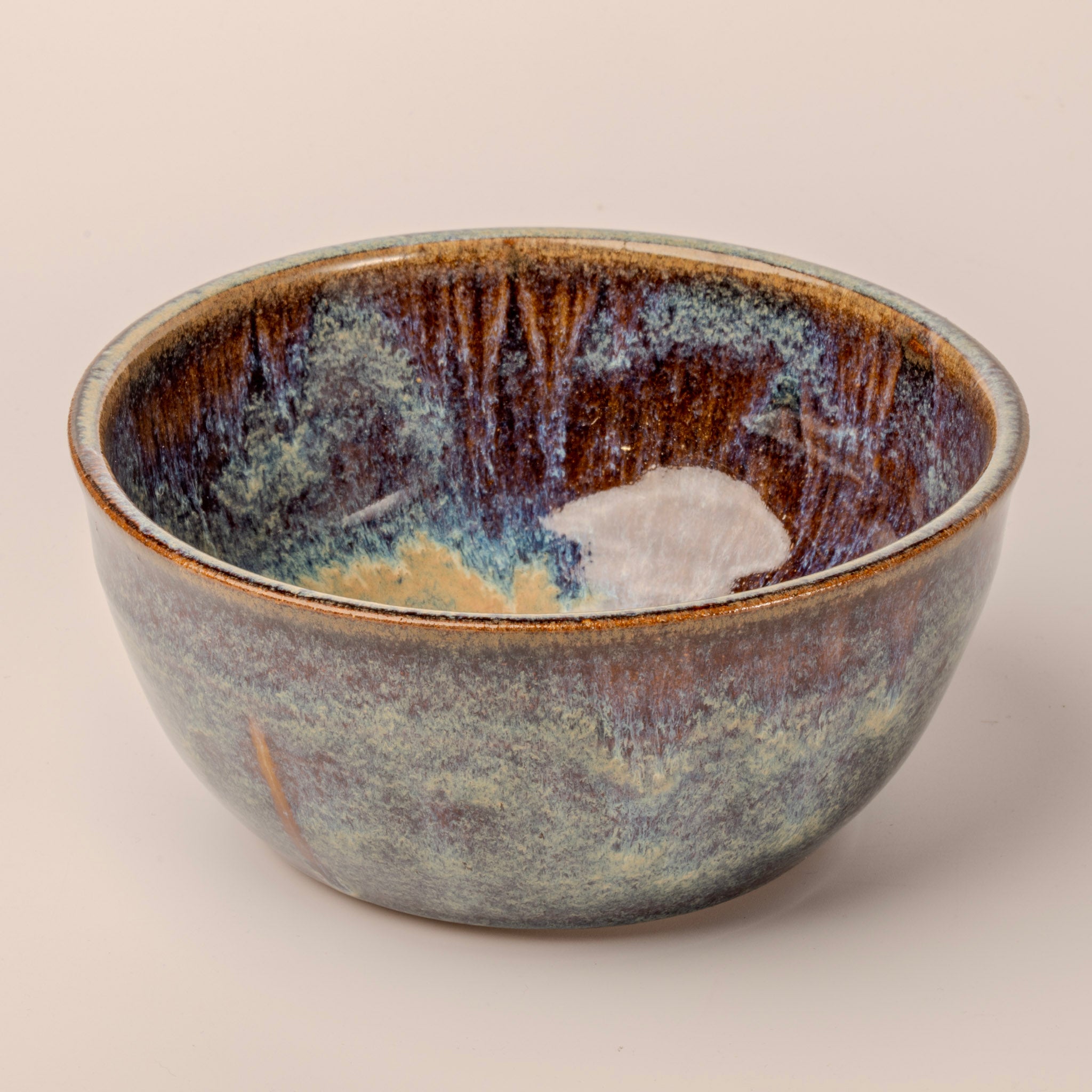 Ceramic bowl with textured surface on a beige background