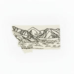 Wooden cutting board with a landscape-themed cutting board insert on a light wooden surface