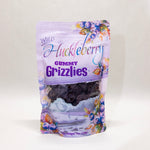 Packaged gummy grizzlies with huckleberry design on a white background