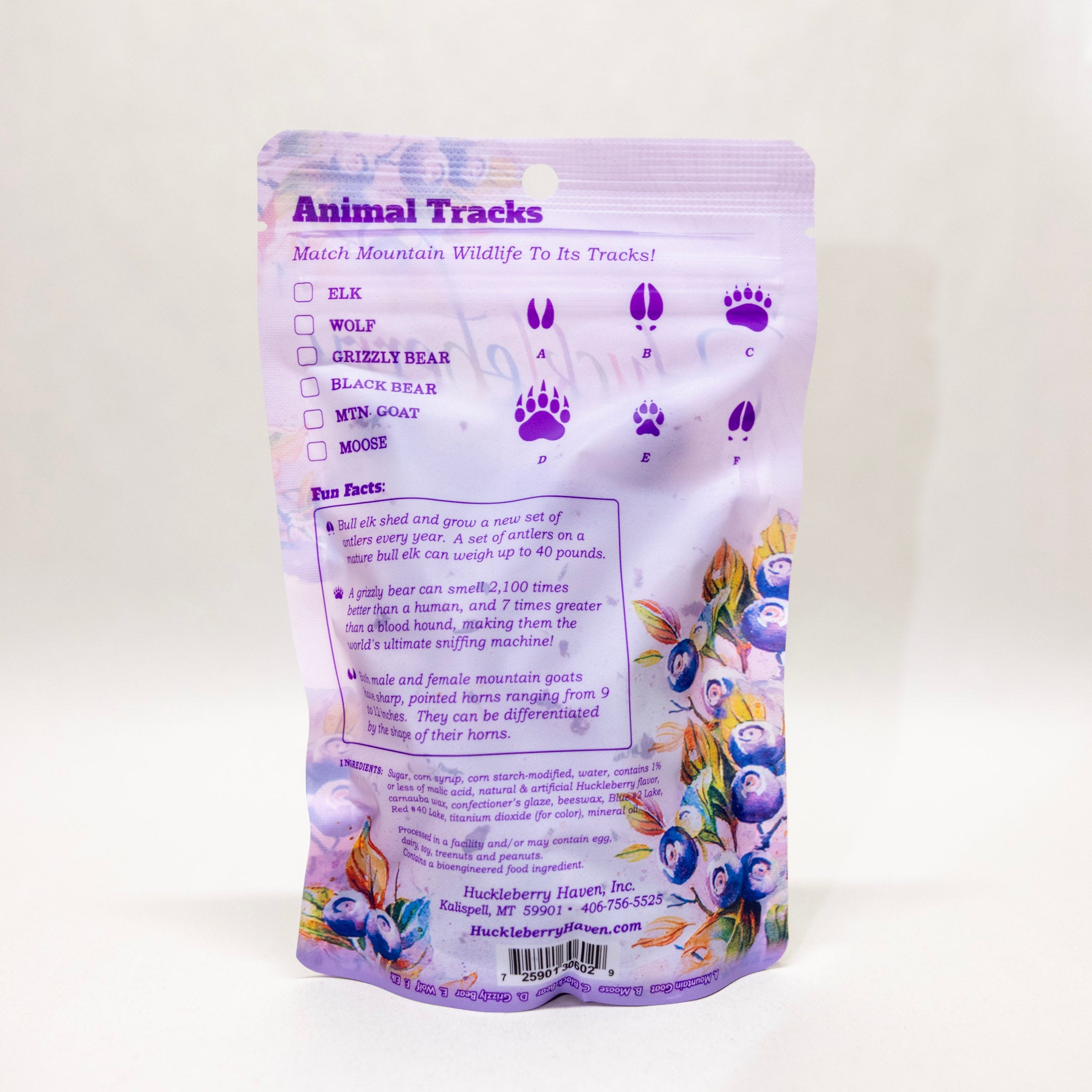 Back of a purple package with animal tracks and blueberry design on a white background