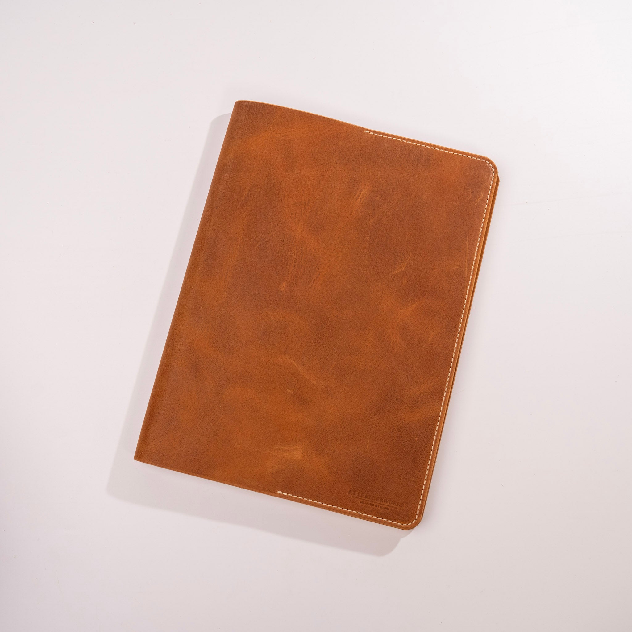 Brown leather notebook on a white background
