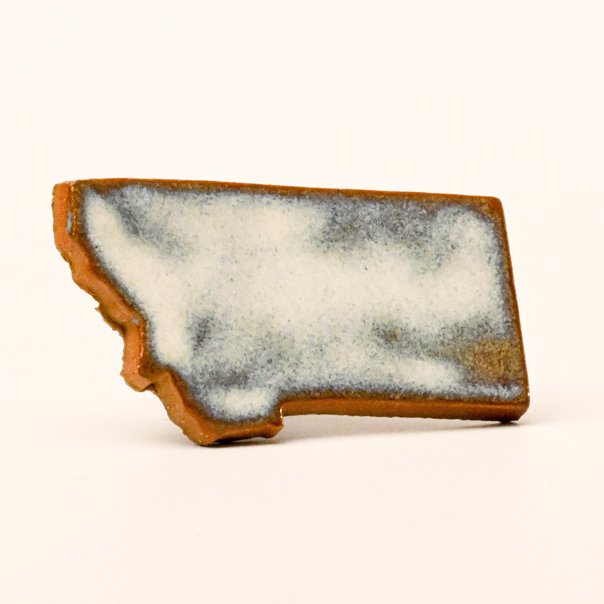 State-shaped magnet with a textured surface on a white background