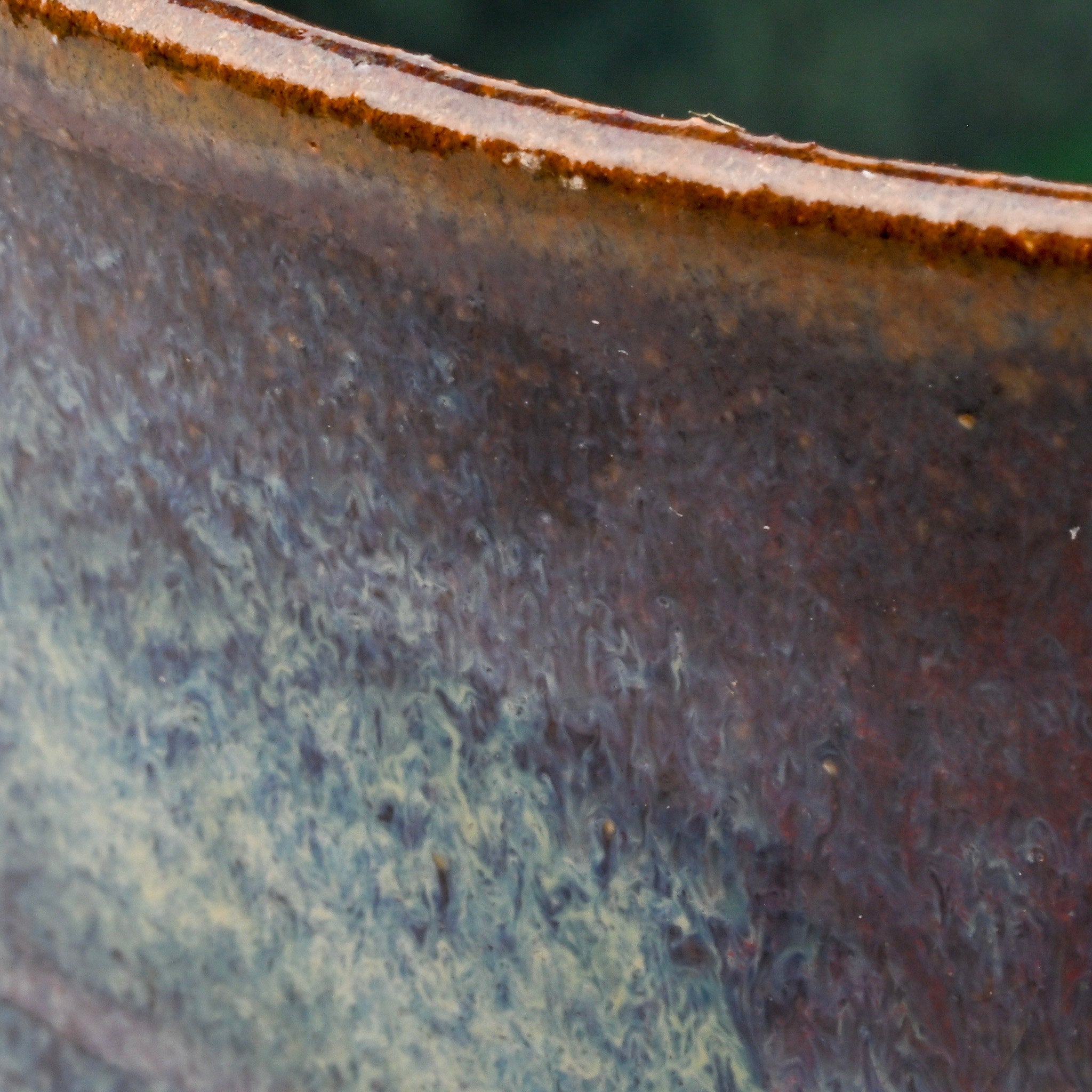 Close-up of a textured surface with a gradient from brown to green.