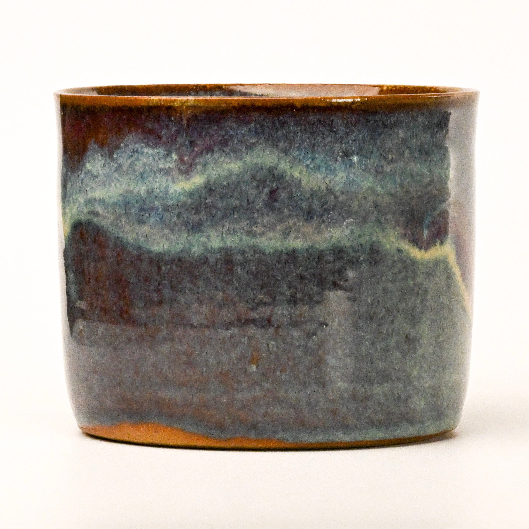 Ceramic pot with a textured surface on a white background