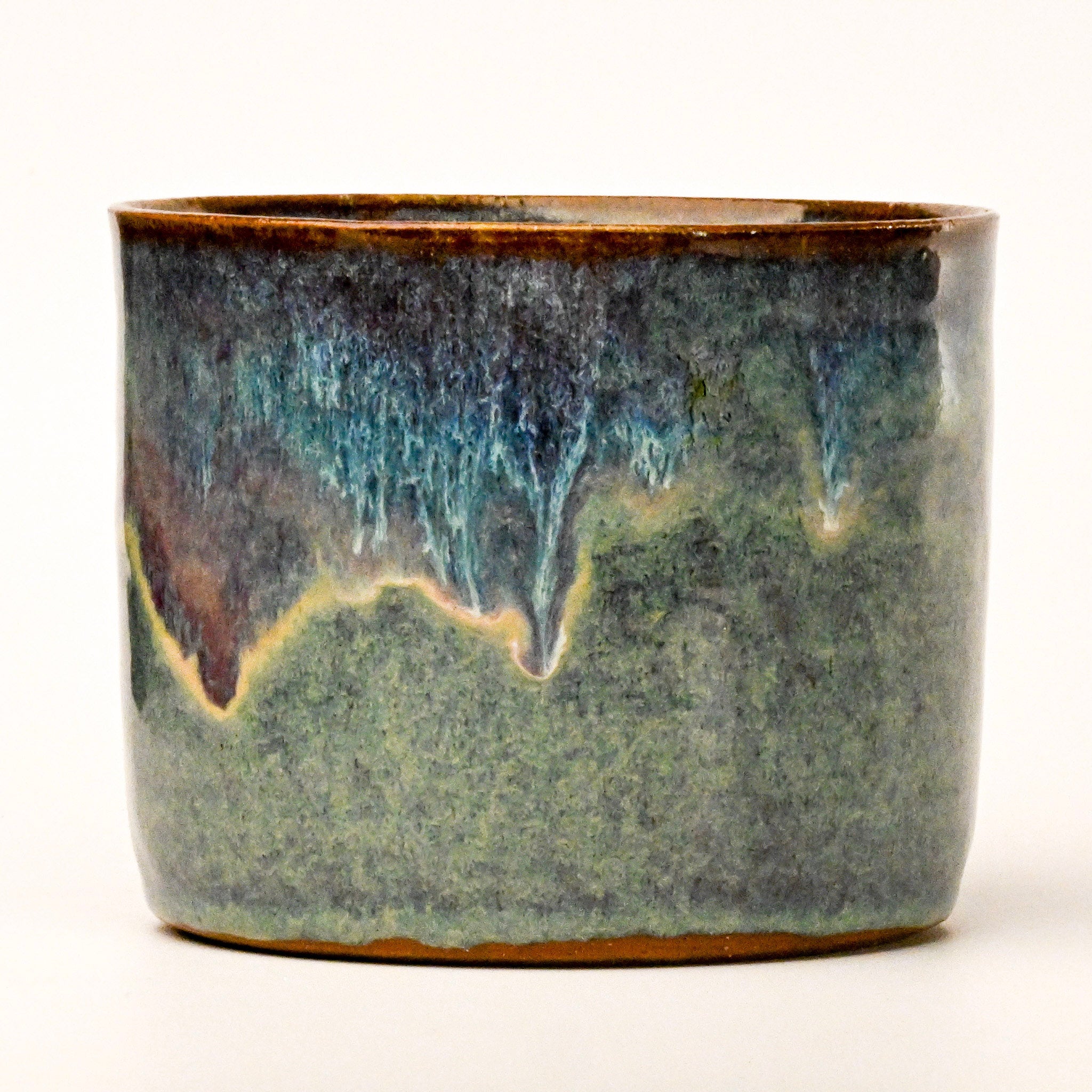 Ceramic pot with a textured surface on a white background