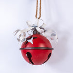 Red bell with white ribbons on a white background