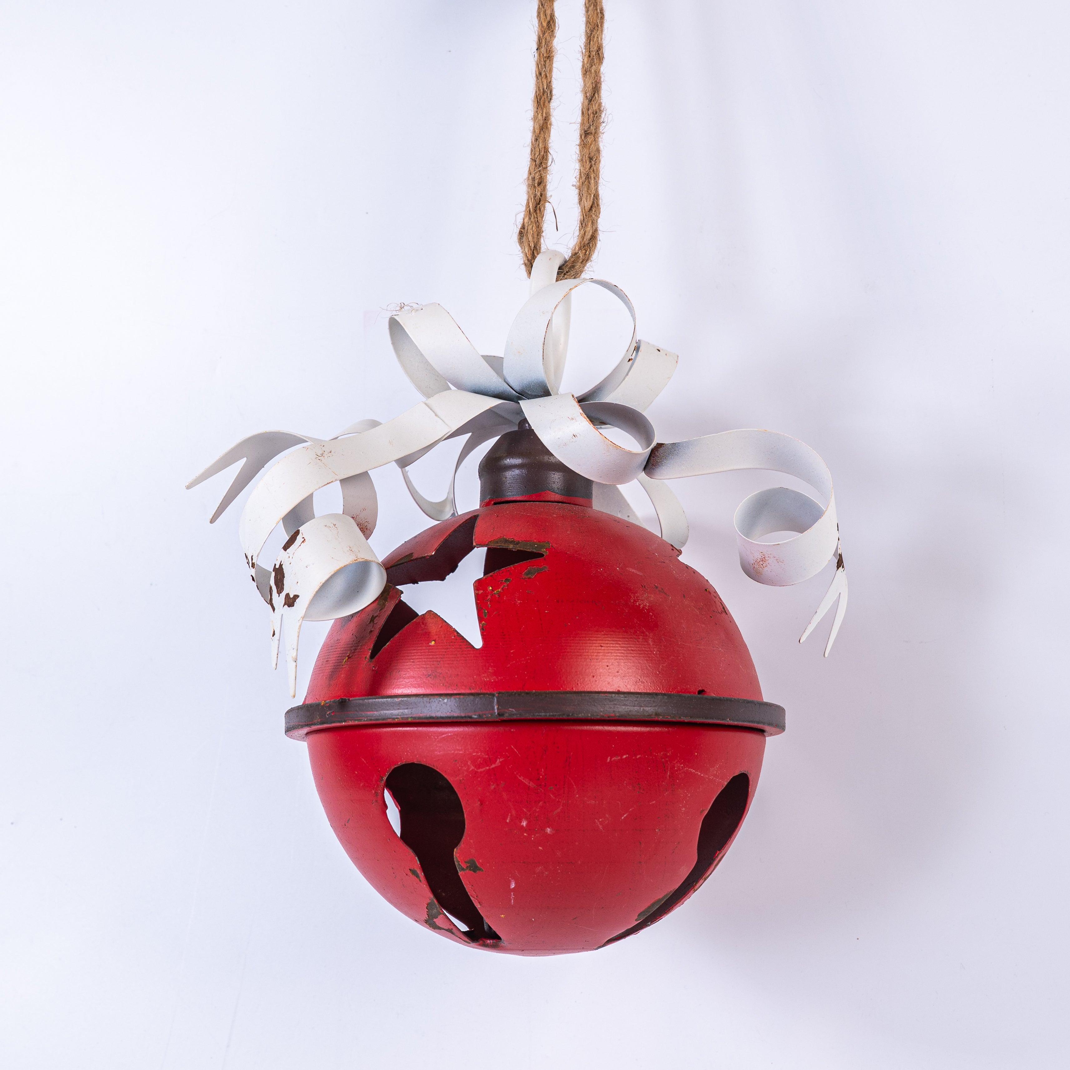Red bell with white ribbons on a white background