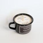 Black mug with a candle inside, branded 'Montana Farmhouse Candle Co.'