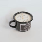 Black mug with a candle inside, branded 'Montana Farmhouse Candle Co.'