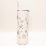 White tumbler with snowflake patterns on a white background