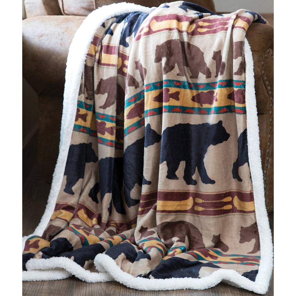 Bear Family Sherpa Throw Blanket by Carstens features a light brown background with a repetitive pattern of black and brown bears, fish, and canoes! 