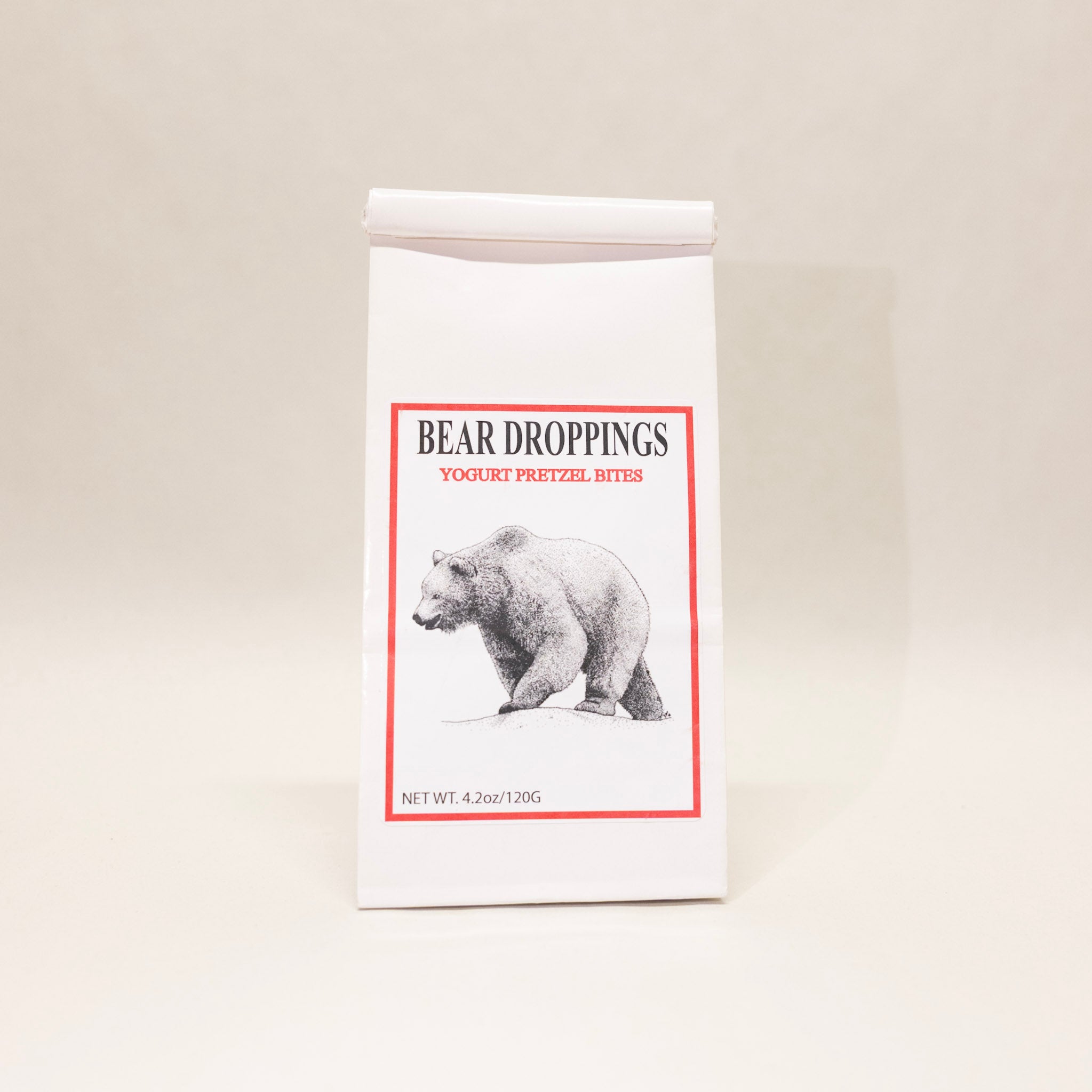 Packaging of 'Bear Droppings' yogurt pretzel bites with a bear illustration on a beige background