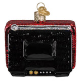 Decorative ornament resembling a vintage television with red and black design on a white background