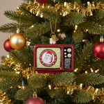Decorative Christmas ornament shaped like a vintage television set on a Christmas tree.
