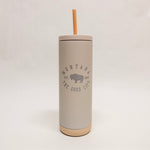 Gray tumbler with straw lid featuring 'Montana the Good Life' text on a light gray background