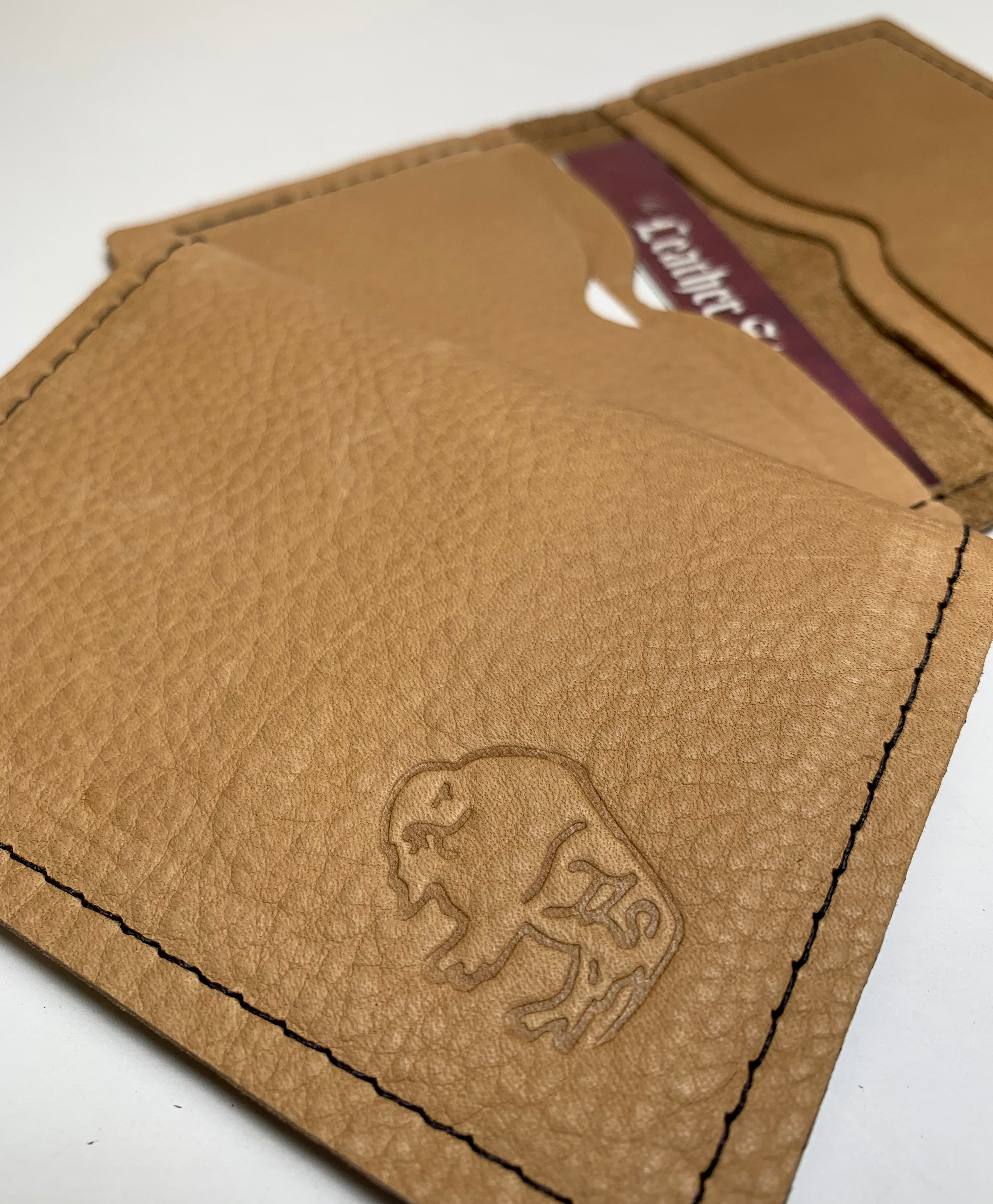 Brown leather wallet with a logo on a white background