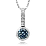 Diamond pendant with blue gemstone on a white background