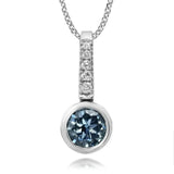 Diamond pendant with blue gemstone on a white background