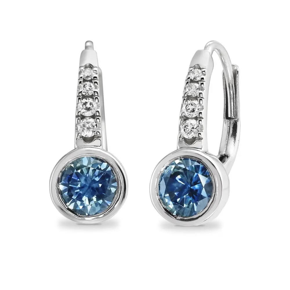 Pair of silver earrings with blue gemstones on a white background