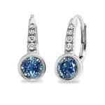Pair of silver earrings with blue gemstones on a white background