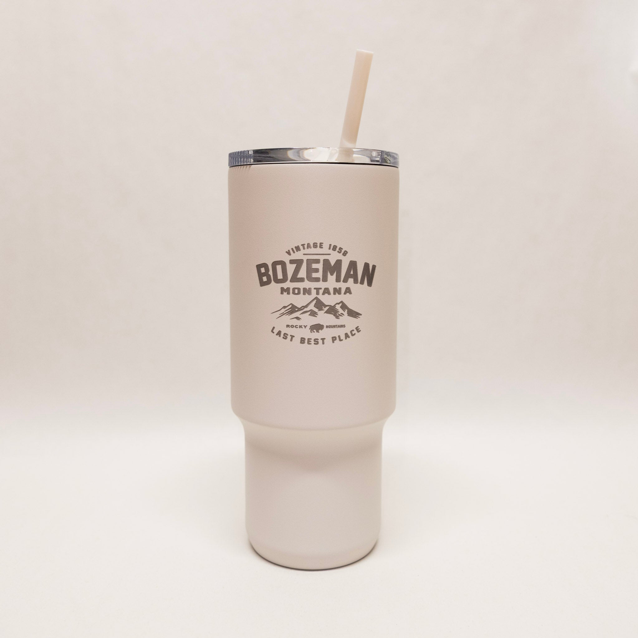 Beige tumbler with 'Bozeman Montana' text and mountain graphic on a white background