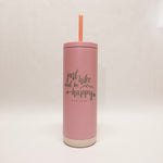 Pink tumbler with a straw on a light beige background