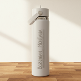 off-White water bottle with 'Bozeman Montana' text on a wooden surface