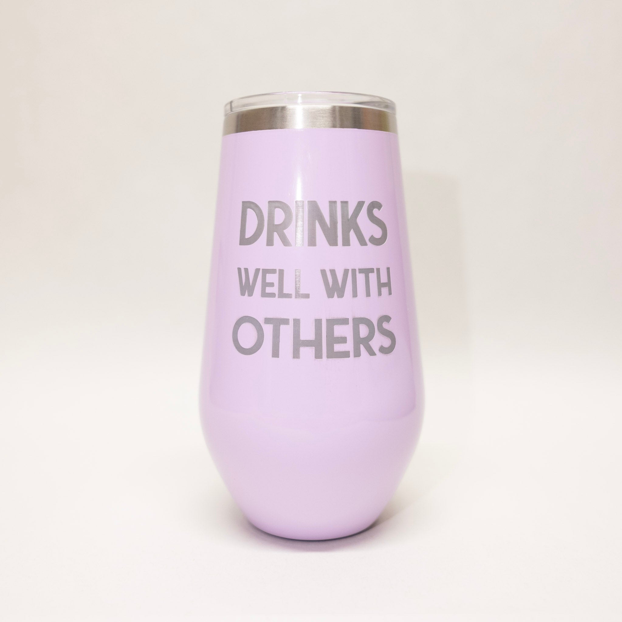 Purple wine tumbler with 'DRINKS WELL WITH OTHERS' text on a white background