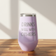Pink tumbler with 'DRINKS WELL WITH OTHERS' text on a wooden surface