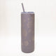 Gray tumbler with leaf patterns and a straw on a white background